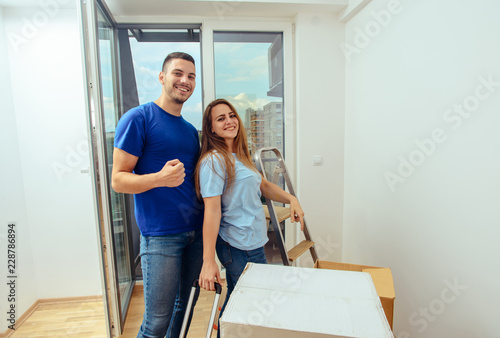 Cheerful couple moving in their new house © qunica.com