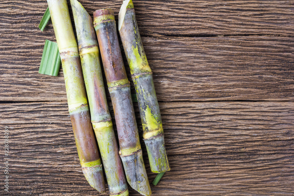 Fototapeta premium Close up sugarcane on wood background close up
