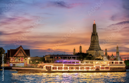 Chao Phraya River Cruise Boat with Temple of the Dawn, Wat Arun, at Sunset in Background, Horizontal