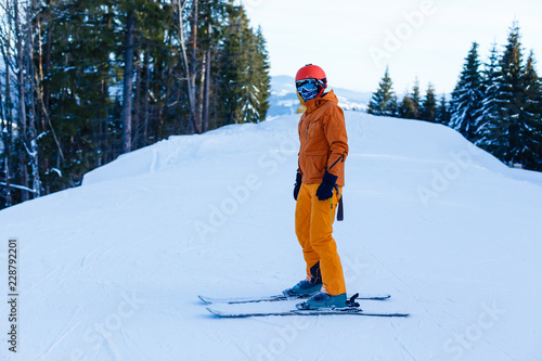 Skier standing on the hill enjoying beautiful scenery
