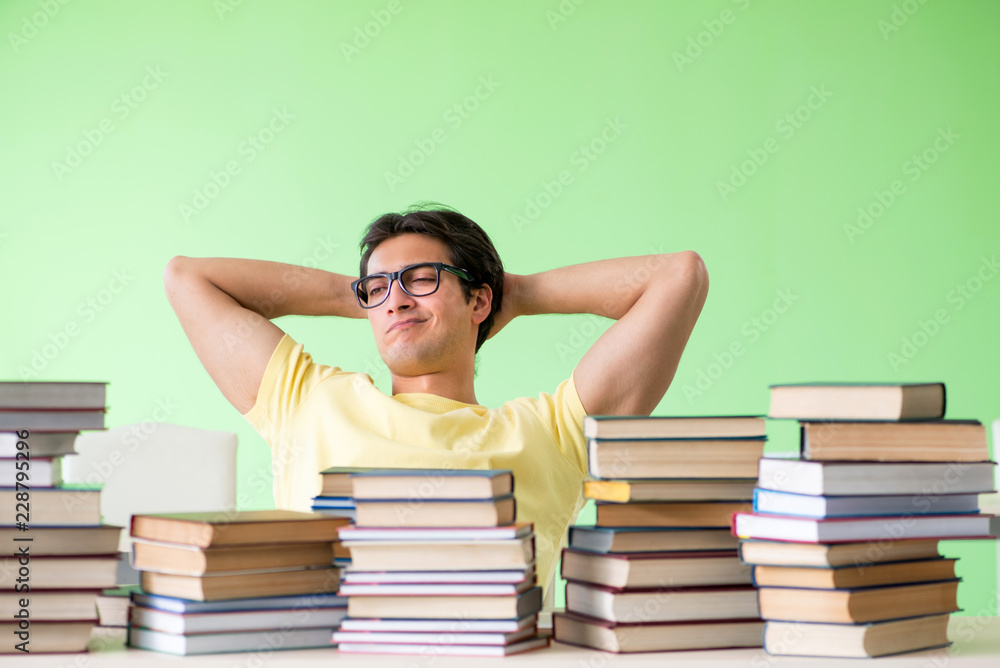Student with too many books to read before exam Student with too many books to read before exam