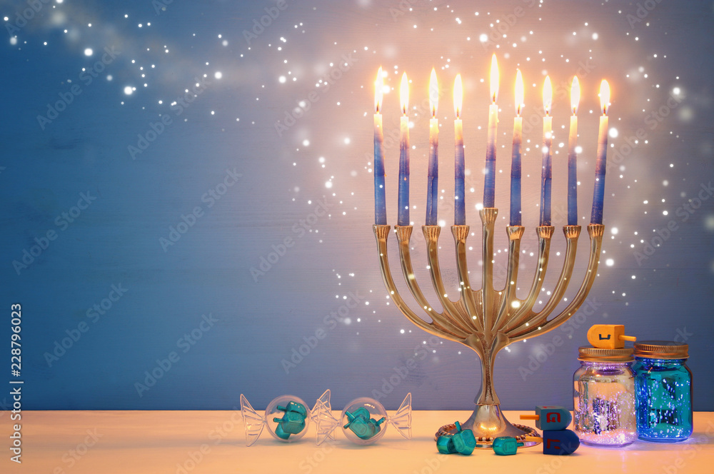 image of jewish holiday Hanukkah background with menorah (traditional candelabra) and candles. image of jewish holiday Hanukkah background with menorah (traditional candelabra) and candles.