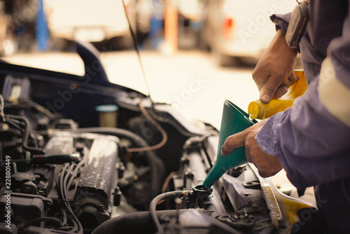 Selective focus,hand of mechanic check water in old car radiator and Add water to car radiator,copy space.