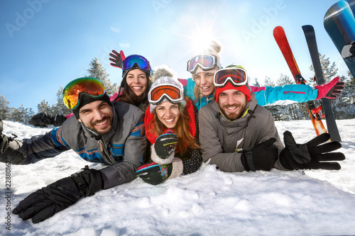 Happy skiers together on winter vacation