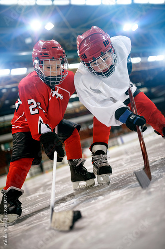 Ice hockey game - action kicking on goal . © luckybusiness