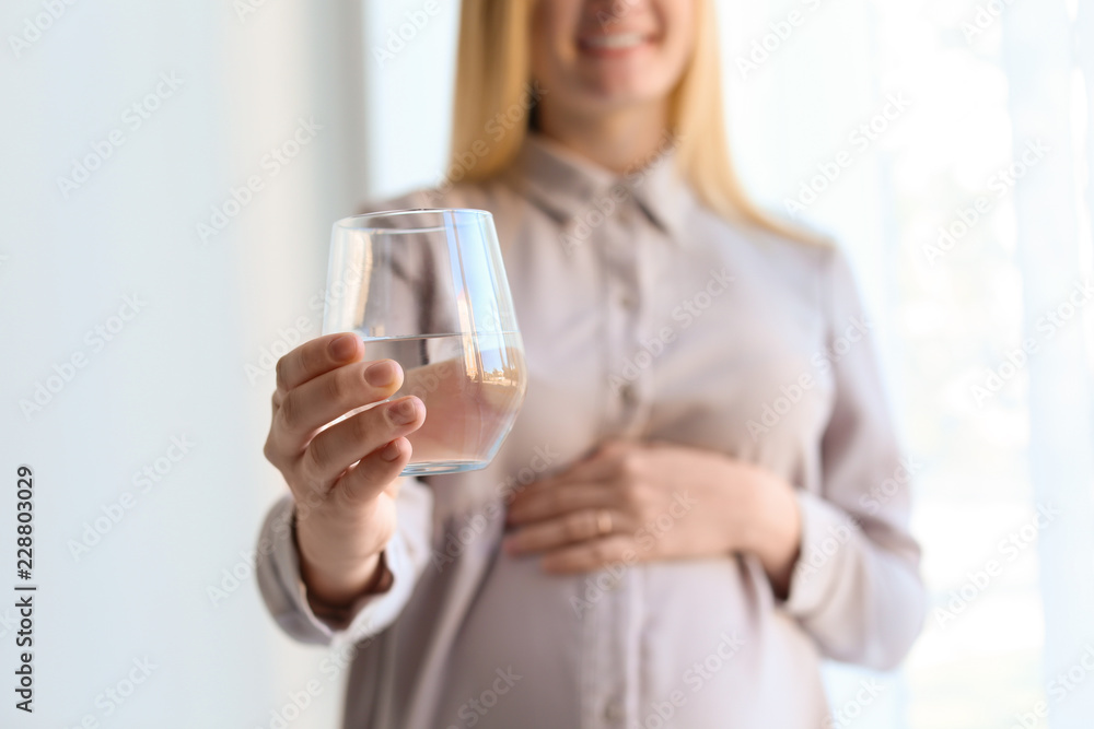 Young pregnant woman with glass of water indoors, closeup Young pregnant woman with glass of water indoors, closeup
