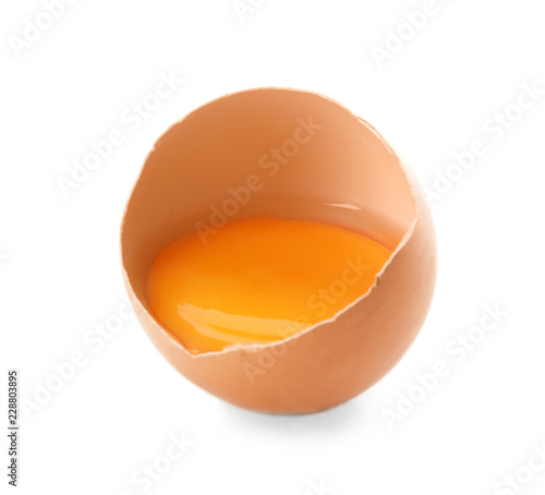 Cracked raw chicken egg with yolk on white background