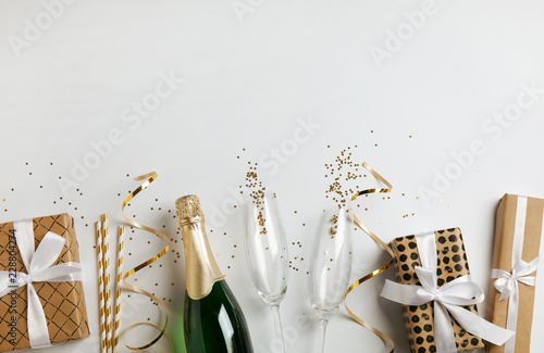 Creative flat lay composition with bottle of champagne and space for text on white background