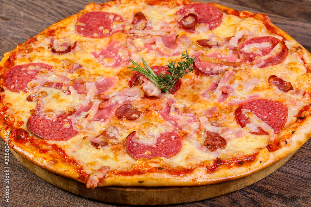 Pizza with ham and sausages