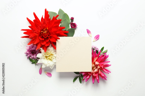 Fototapeta Naklejka Na Ścianę i Meble -  Flat lay composition with beautiful dahlia flowers and blank card on white background