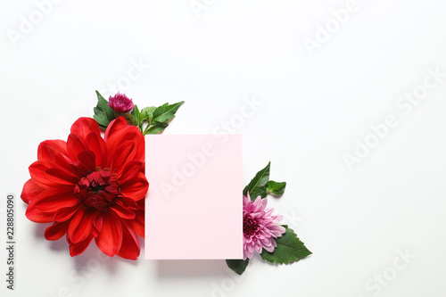 Fototapeta Naklejka Na Ścianę i Meble -  Flat lay composition with beautiful dahlia flowers and blank card on white background