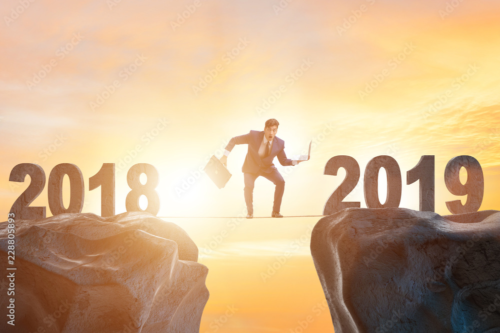 Businessman balancing between 2018 and 2018 Businessman balancing between 2018 and 2018