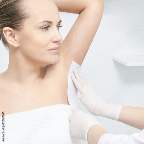 Unwanted hair wax epilation. Young Woman. cosmetology salon treatment procedure. Home waxing