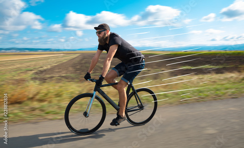 Casual hipster cyclist riding bicycle with high speed concept