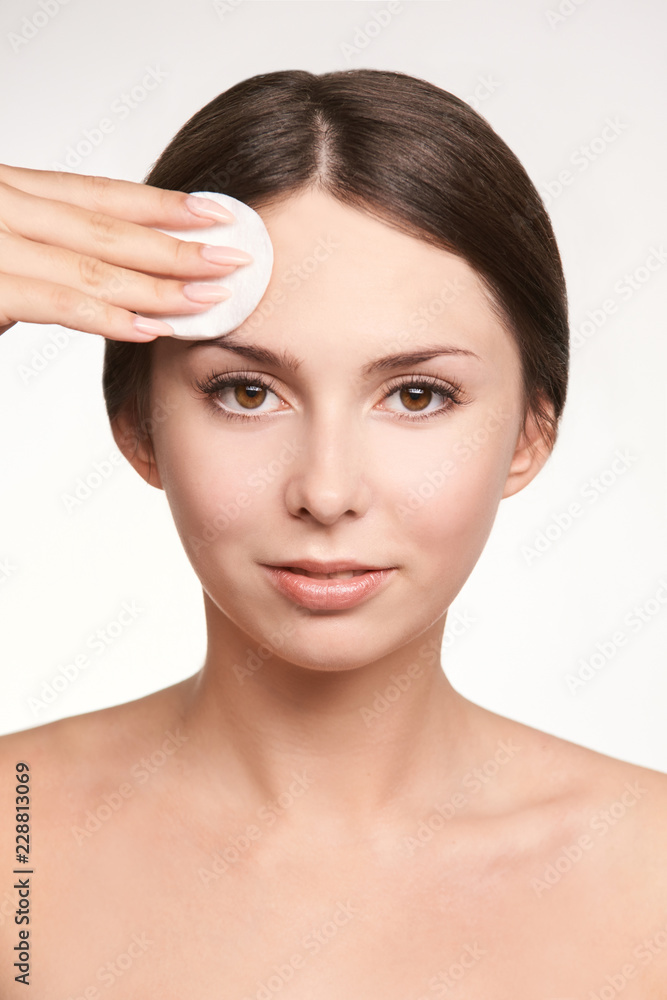 Young white girl remove mascara. Face makeup