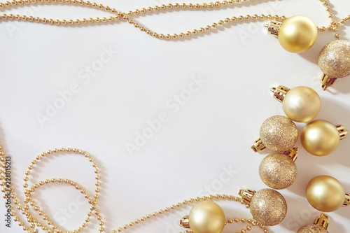 Colden Christmas balls on white background. New year backdrop.