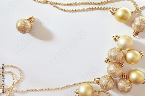 Colden Christmas balls on white background. New year backdrop.