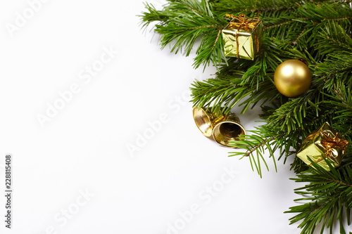 Fir tree branches and Christmas decorations on white background.
