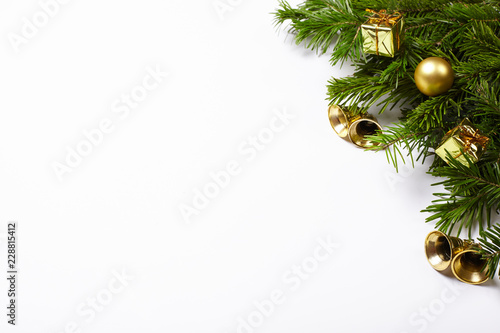 Fir tree branches and Christmas decorations on white background.