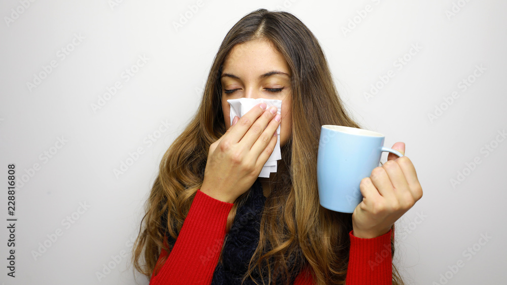Young woman sick with cold or flu drinks something hot Young woman sick with cold or flu drinks something hot