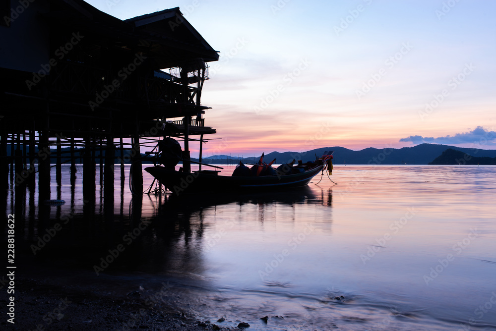 Sunset over lake with silhouette fishinng home,boat and indutstrail fishing on foreground at southern Thailand background. Sunset over lake with silhouette fishinng home,boat and indutstrail fishing on foreground at southern Thailand background.