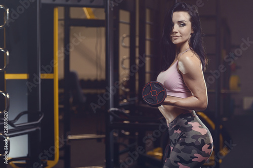 Beautiful sexy athletic young girl working out in gym © antondotsenko