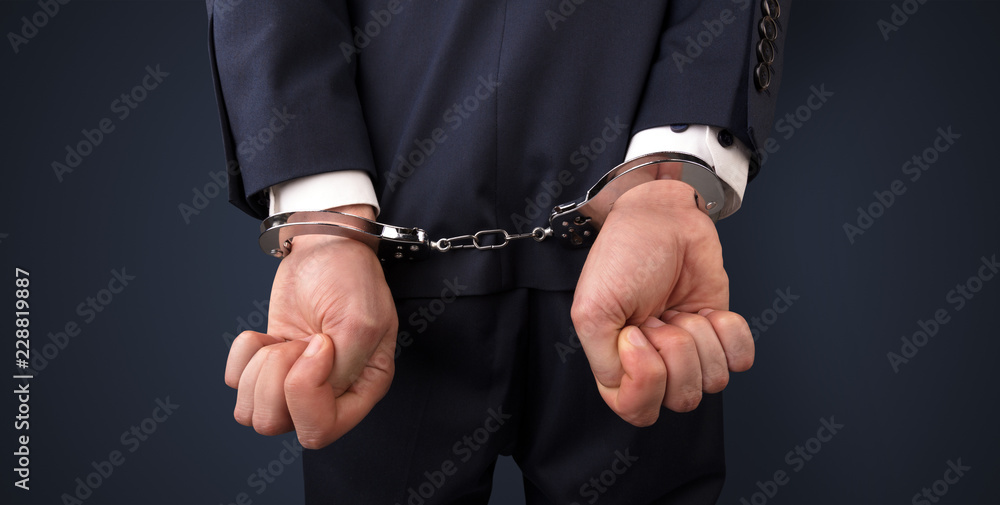 Close now arrested men hand with dark background and handcuffs
Close now arrested men hand with dark background and handcuffs