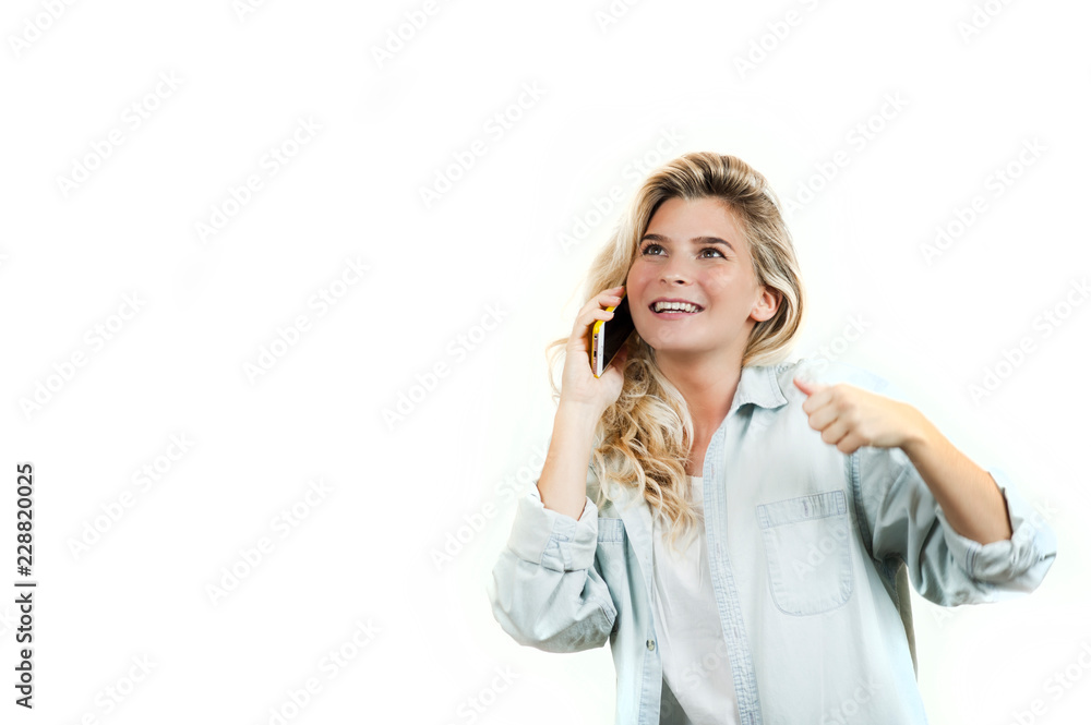 very beautiful young girl talking on the phone while standing on a white isolated background. very beautiful young girl talking on the phone while standing on a white isolated background.