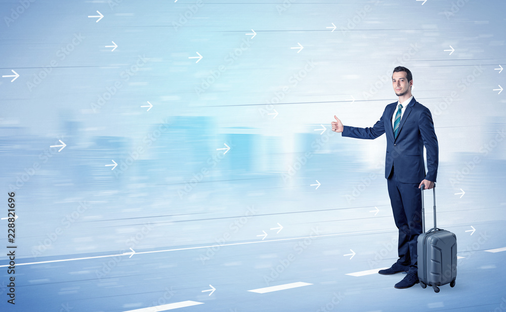 Young businessman hitchhiking near the city with arrows around concept Young businessman hitchhiking near the city with arrows around concept