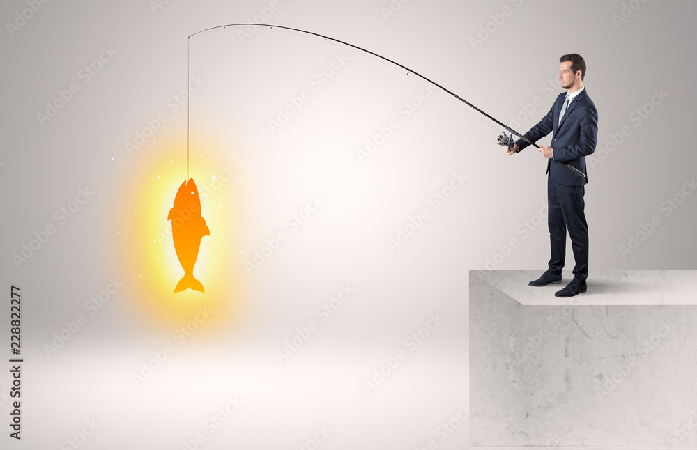 Young businessman fishing golden fish from the top of a building
Young businessman fishing golden fish from the top of a building