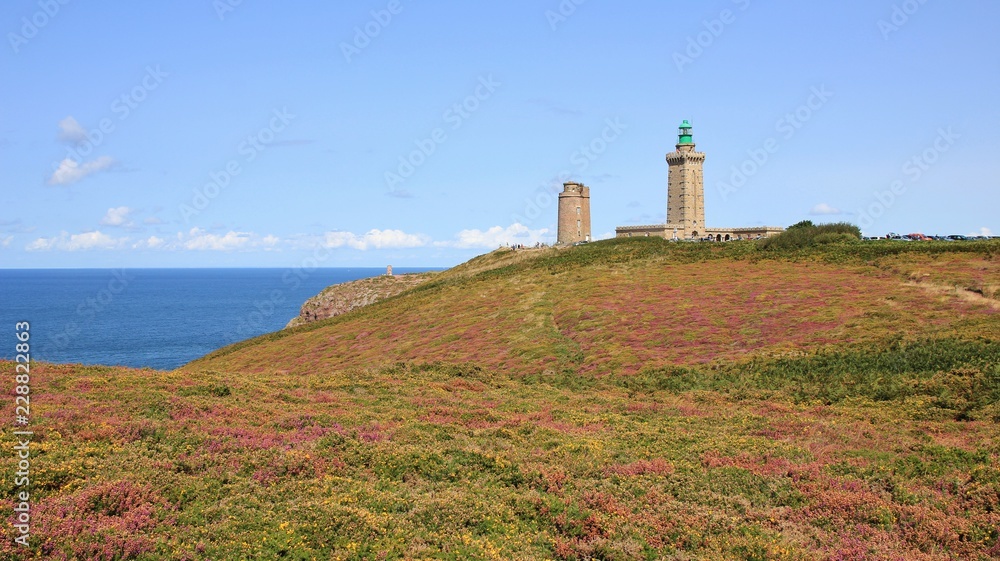 Old lighthouse and flowers at Cap Frehel, Brittany. English Channel.