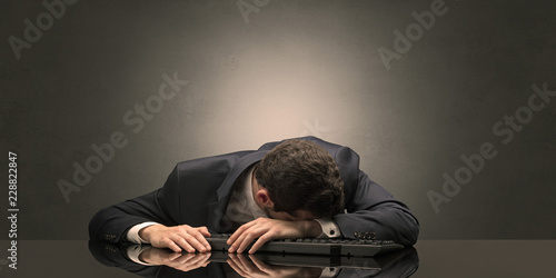 Young businessman fell asleep at his workplace with copy space