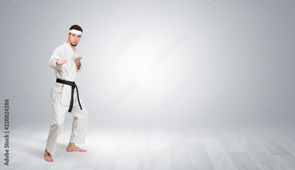 Young kung-fu trainer fighting in an empty space
Young kung-fu trainer fighting in an empty space
