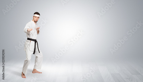 Young kung-fu trainer fighting in an empty space 