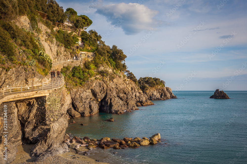 The coast of Monterosso with steep rocks and the Mediterranean scrub overlooking the sea. Cinque Terre, Italy