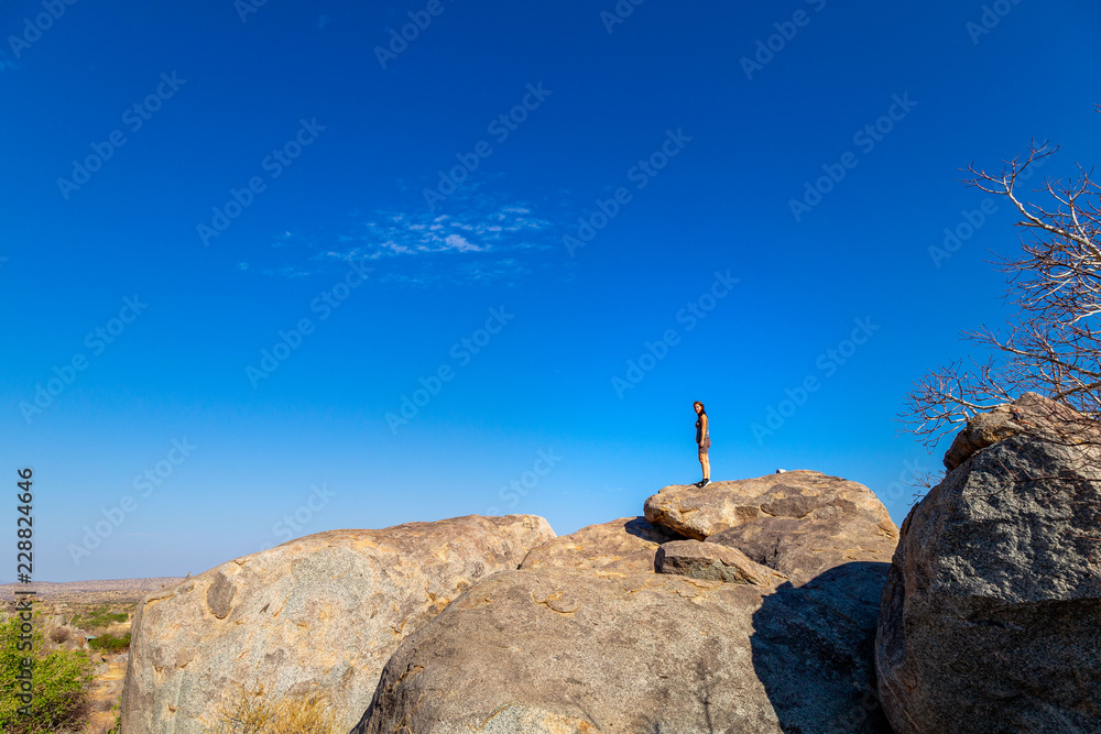 Fototapeta premium Femme debout sur rochers montagne Namibie