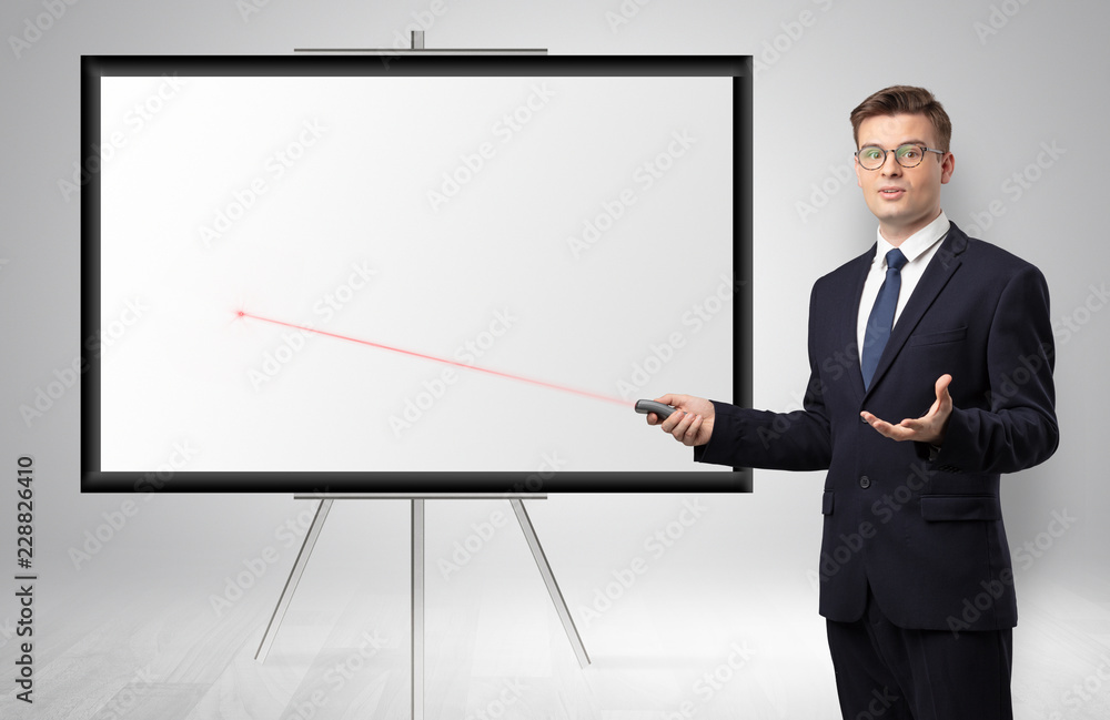 Young businessman with laser pointer and copyspace white wall
Young businessman with laser pointer and copyspace white wall