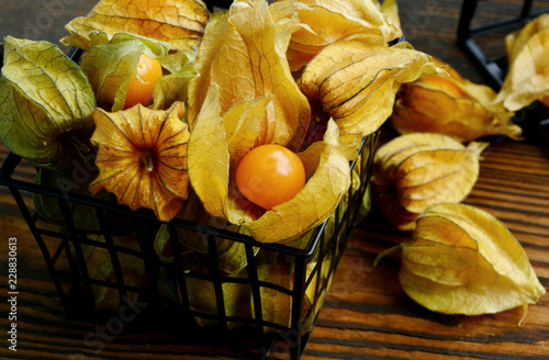 Fotografija Close up Cape gooseberries or Physalis on wooden background with shadow