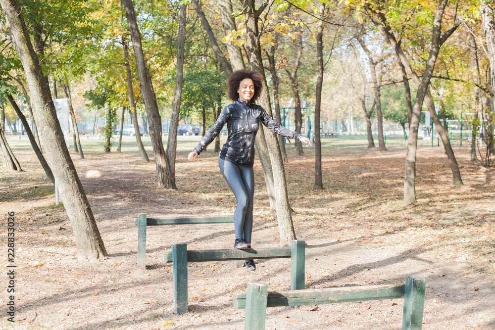 African Woman Running And Jumping Over Hurdles In Forest African Woman Running And Jumping Over Hurdles In Forest