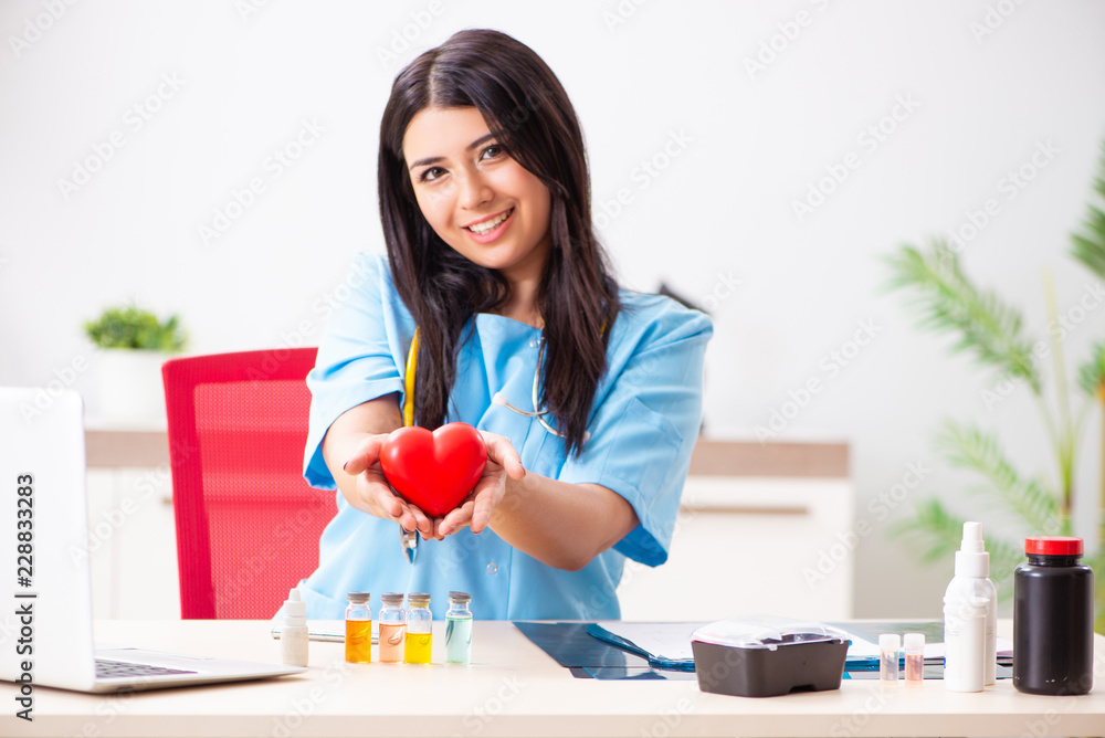 Young beautiful female doctor working in the clinic Young beautiful female doctor working in the clinic