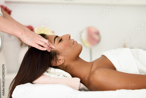 Woman receiving head massage in spa wellness center. photo