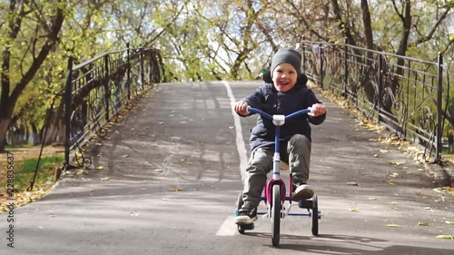 Wallpaper Mural Joyful little boy riding a bike (tricycle) Torontodigital.ca