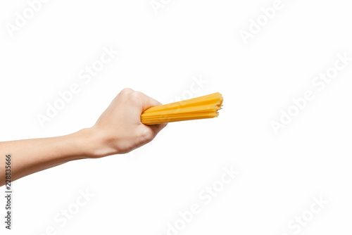 Femal hand holding pasta. Fodd Concept. White background, isolated, close up