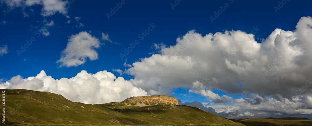 Panoramic view of the mountain plateau in the clouds in the summer,  North Caucasus in Russia.