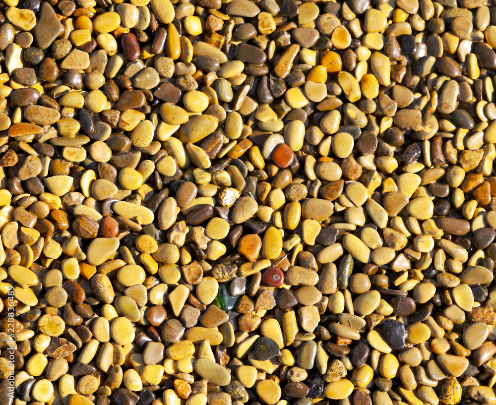 Small yellow stones on the road surface as background