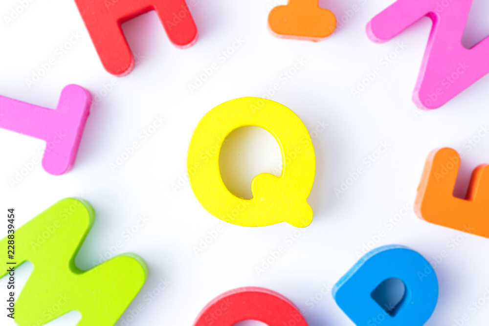 Q letters in English made from wood bright colors. Q letters in English made from wood bright colors.