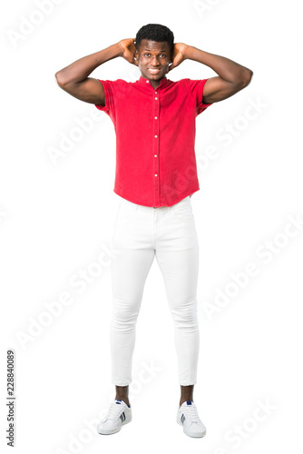 Full body of Young african american man takes hands on head because has migraine on white background