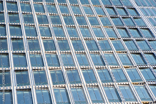 Windows of the office building with the sky reflections