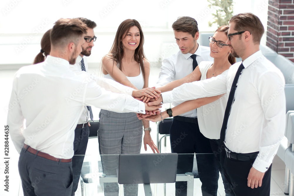 business colleagues folded their hands together business colleagues folded their hands together