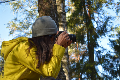 Photographer trying to capture a good nature photograph in the forest.